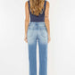 Back view of model wearing High Waist Chewed Up Straight Mom Jeans with distressed holes and frayed edges for a trendy, vintage-inspired look.