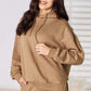 Woman wearing RISEN Drawstring Drop Shoulder Long Sleeve Hoodie in beige, showing casual and comfy style for lounging or casual outings.