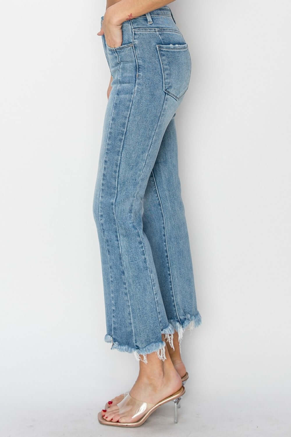 High Rise Frayed Hem Flare Jeans by Risen Jeans, featuring a trendy bohemian-inspired look with flare legs and an edgy frayed hem.