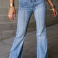 Petite high waist bootcut jeans for women in light blue denim with pocket details, styled with a black top and gold bracelet.