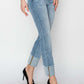 Woman wearing Risen high rise cuffed slim straight jeans with heels, showing trendy cuffed hem and flattering high waist design