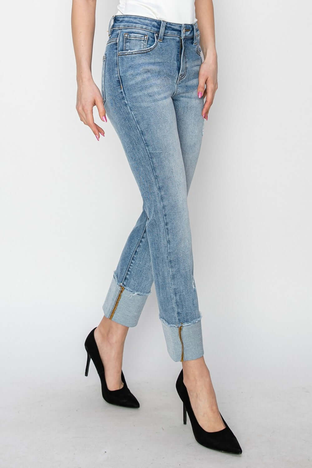 Woman wearing Risen high rise cuffed slim straight jeans with heels, showing trendy cuffed hem and flattering high waist design