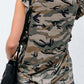 Woman wearing Bella Road Ruffled Printed Round Neck Cap Sleeve T-Shirt in camouflage pattern, paired with black shorts.