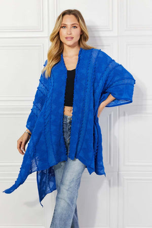 JUSTIN TAYLOR Pom-Pom Asymmetrical Poncho Cardigan in Blue at Bella Road