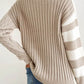 Woman wearing Bella Road tan cable-knit color block round neck sweater with jeans, showcasing cozy fall fashion.