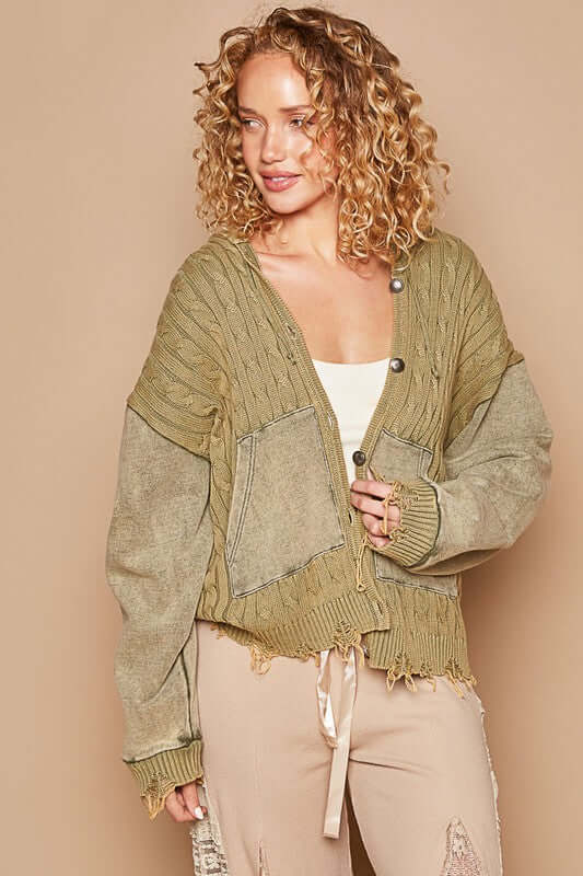 Stylish woman in an olive green distressed hem button-up hooded cardigan, showcasing casual comfort and trendy warmth.