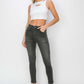 Woman wearing RISEN full size high rise ankle skinny jeans with a white crop top and black sandals