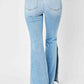 Back view of Judy Blue Jeans Mid Rise Raw Hem Slit Flare in light wash, featuring pocket detail and retro-inspired flare hem.