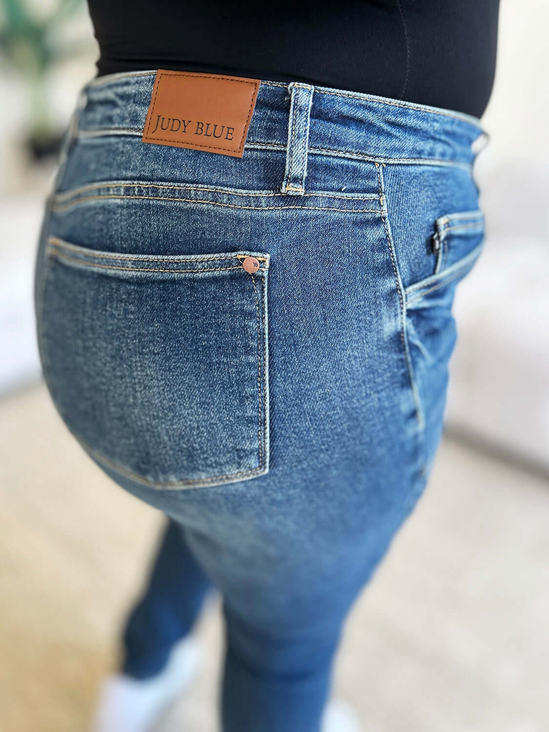 Close-up of High Waist Judy Blue Skinny Jeans back pocket and logo in stretchy denim fabric