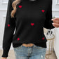 Woman wearing Devine Lace Detail Heart Long Sleeve Sweater with red heart details, perfect for cozy and romantic occasions.