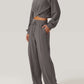 Woman wearing Bella Road Crisscross Round Neck Top and Drawstring Pants Set in grey, showcasing stylish and comfortable two-piece outfit.