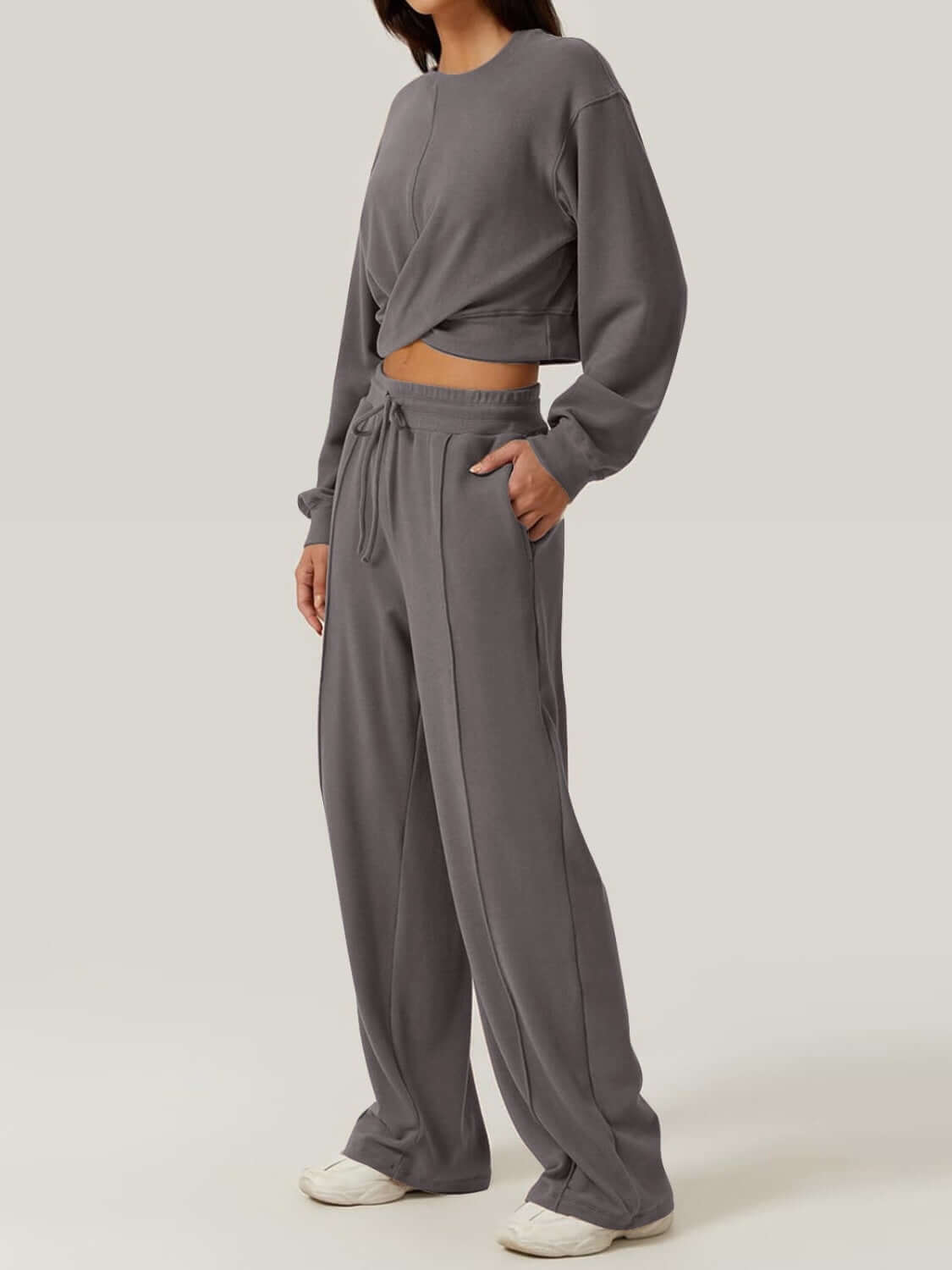 Woman wearing Bella Road Crisscross Round Neck Top and Drawstring Pants Set in grey, showcasing stylish and comfortable two-piece outfit.