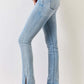 Woman wearing Mid Rise Y2K Slit Bootcut Jeans in light blue, showcasing side slit detail and paired with high heels for a stylish look