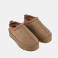 Trendy beige platform slip-on boots with embroidered trim, offering style and comfort for daily wear.