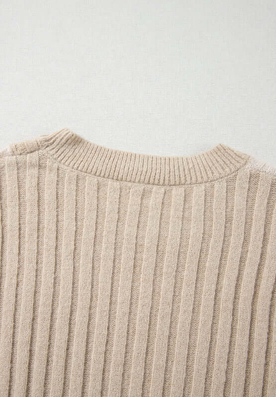 Close-up of Bella Road tan cable-knit sweater with round neck and color block design. Cozy, stylish, perfect for cool days.