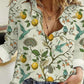 Woman wearing Bella Road Lemon Printed Collared Neck Long Sleeve Shirt with buttoned front and rolled-up sleeves.