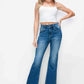 Model showcasing bytos full size high rise bootcut jeans with pockets, paired with a white crop top and stylish heels.