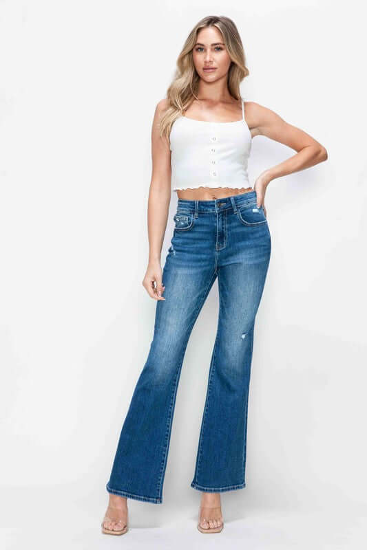 Model showcasing bytos full size high rise bootcut jeans with pockets, paired with a white crop top and stylish heels.