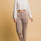 Woman wearing Love Tree High Rise Cargo Pants with pockets, paired with a chic cropped top for a trendy, comfortable look.