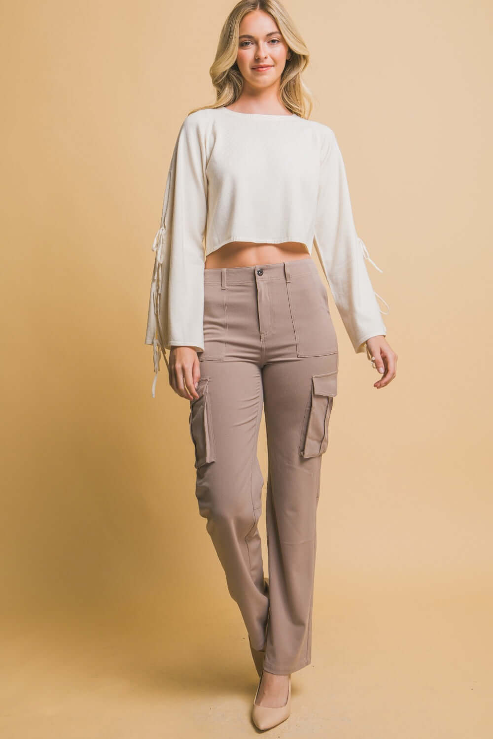 Woman wearing Love Tree High Rise Cargo Pants with pockets, paired with a chic cropped top for a trendy, comfortable look.