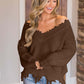 Woman wearing Bella Road frayed hem dropped shoulder sweater in brown, paired with jeans, showcasing casual and stylish fall fashion.