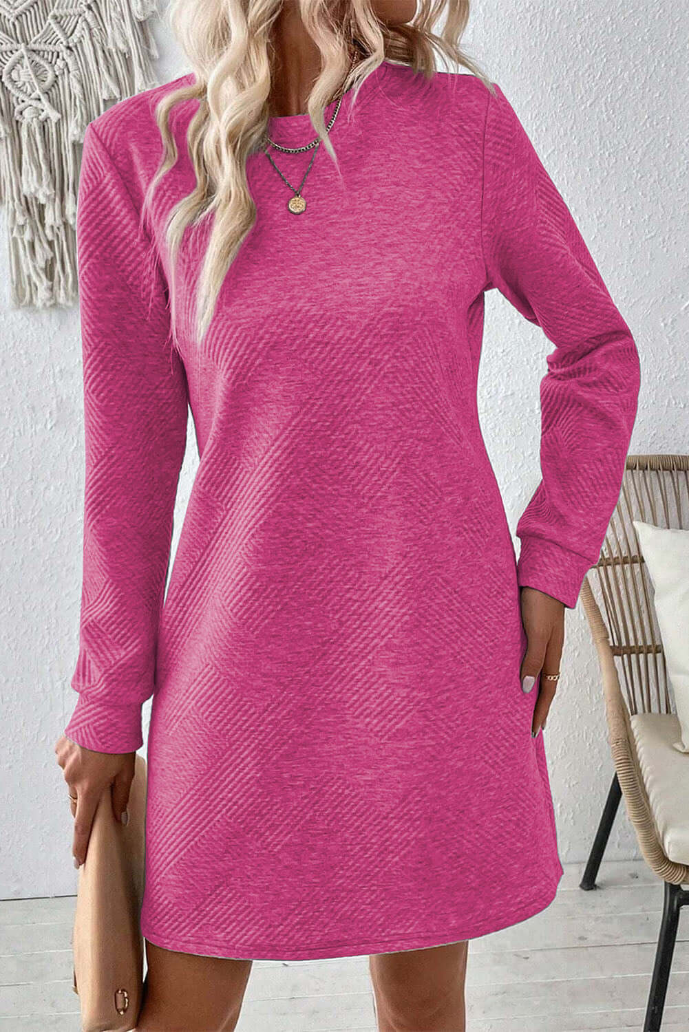 Bella Road textured pink mini dress with long sleeves and a round neck, perfect for casual outings.