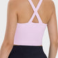 Back view of Millennia Crisscross Grecian Neck Active Cami in soft pink, showcasing stylish crisscross straps.