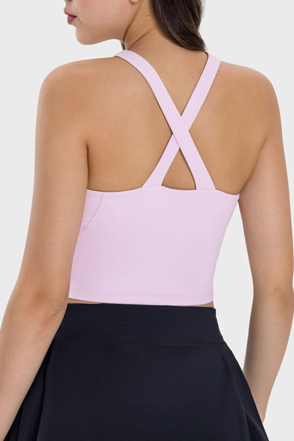 Back view of Millennia Crisscross Grecian Neck Active Cami in soft pink, showcasing stylish crisscross straps.