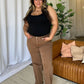 Woman wearing RFM Full Size High Rise Garment Dye Wide Leg Jeans in a stylish setting with a comfortable, flattering fit.