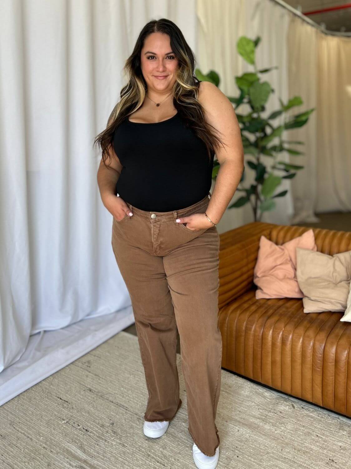 Woman wearing RFM Full Size High Rise Garment Dye Wide Leg Jeans in a stylish setting with a comfortable, flattering fit.