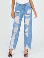 Woman wearing Raw Hem Distressed Straight Jeans with multiple rips, featuring no stretch, made of 100% polyester, blue color