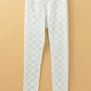 Bella Road white checkered elastic waist leggings hanging on a wooden hanger against a beige background