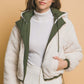 Woman wearing a Love Tree zip-up cropped hooded Sherpa reversible jacket in cream and green, showcasing its cozy and stylish design.