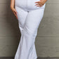 Woman wearing Raelene High Waist Wide Leg Jeans in White from Risen Jeans, showing chic retro flair with wide-leg design and high-rise waistline