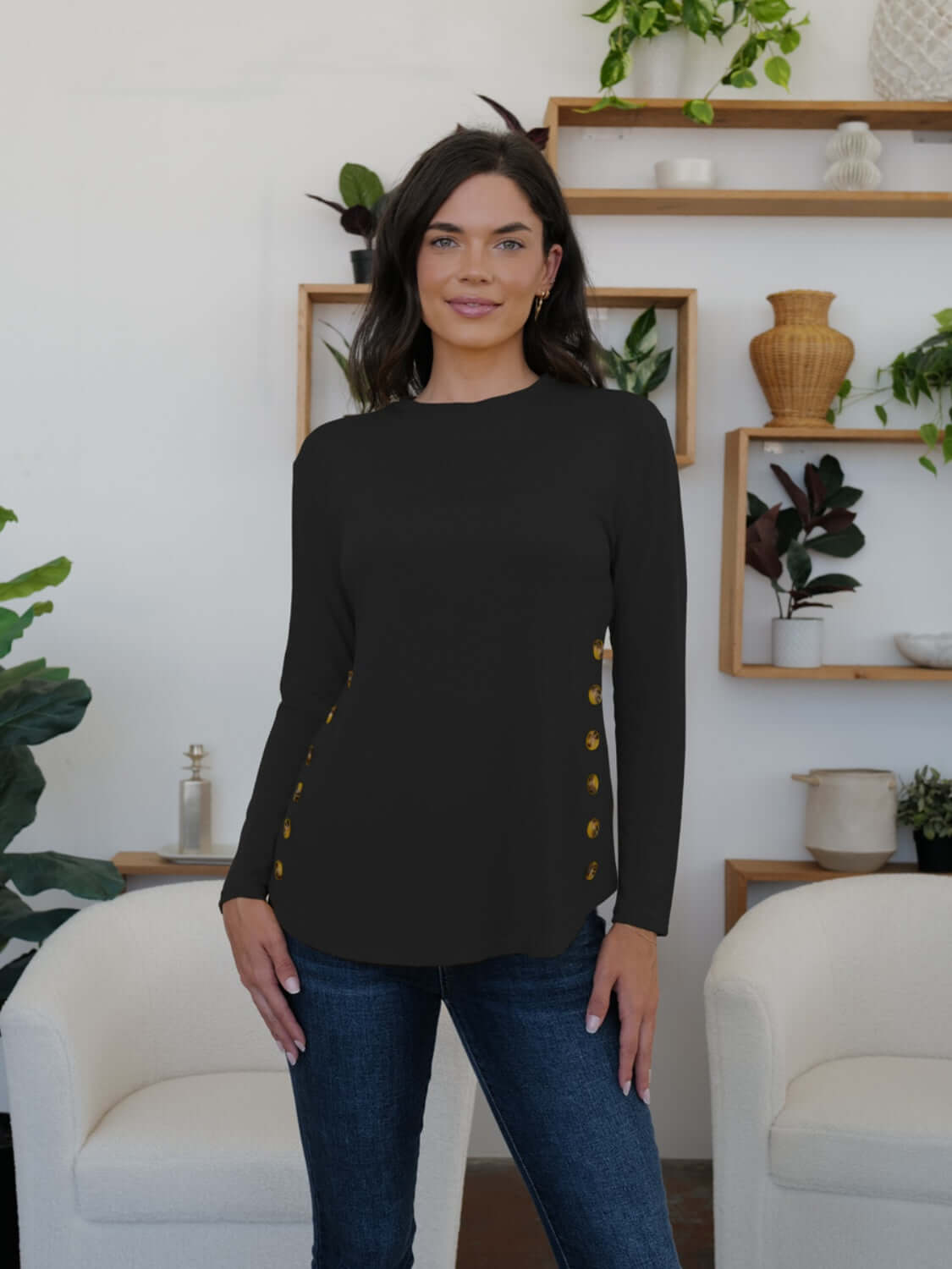 Woman wearing FAM-FAM Round Neck Long Sleeve T-Shirt with decorative buttons, perfect for casual style, in a cozy living room setting.