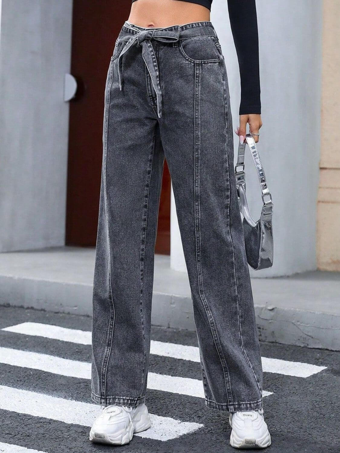 Woman wearing Bella Road Tied Straight Leg Jeans with Pockets, stylish and comfortable denim perfect for everyday look, slightly stretchy.