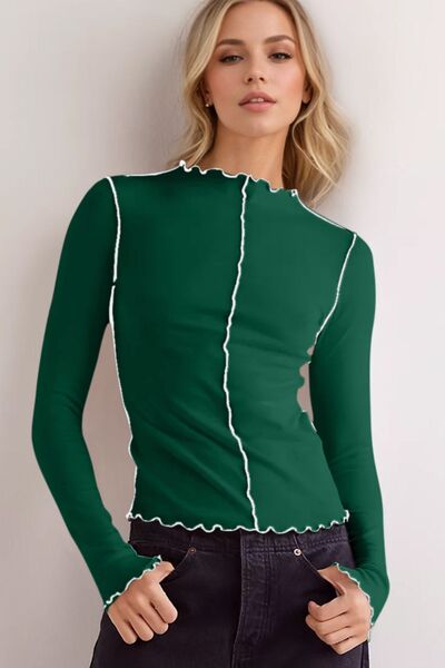 Model wearing a green mock neck long sleeve T-shirt with white contrast trim, styled casually.