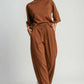 Model showcasing Umgee full size drawstring wide leg pants with pockets in warm brown, styled for comfort and elegance.