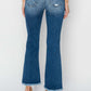 Model wearing Risen Jeans frayed step hem ankle straight jeans, showcasing back view with trendy distressed details and frayed hems.