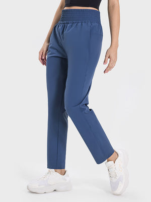 Stylish blue Millennia high waist active pants featuring a pocketed design and comfortable stretch. Perfect for workouts!