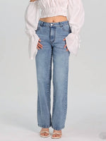 Woman wearing Bella Road Straight Jeans with Pockets, styled with a white top, showcasing their comfy fit and versatility.