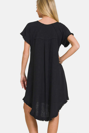 Woman wearing a black Fringe Edge High Low Flowy Dress with Pockets, showcasing its back and high-low hem design.