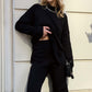 Woman wearing Basic Bae Side Slit Turtleneck Sweater with dropped shoulders, showcasing cozy style and elegant black outfit.