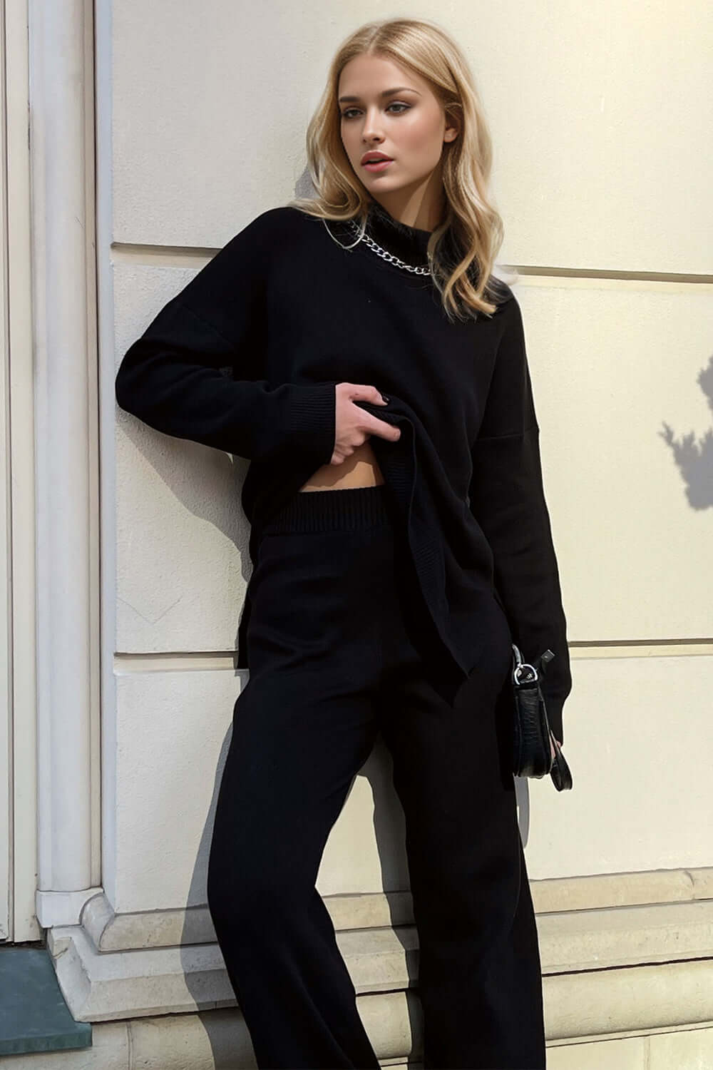 Woman wearing Basic Bae Side Slit Turtleneck Sweater with dropped shoulders, showcasing cozy style and elegant black outfit.