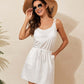 Woman wearing white drawstring scoop neck sleeveless cover up dress with openwork details, accessorized with sunglasses and a sun hat