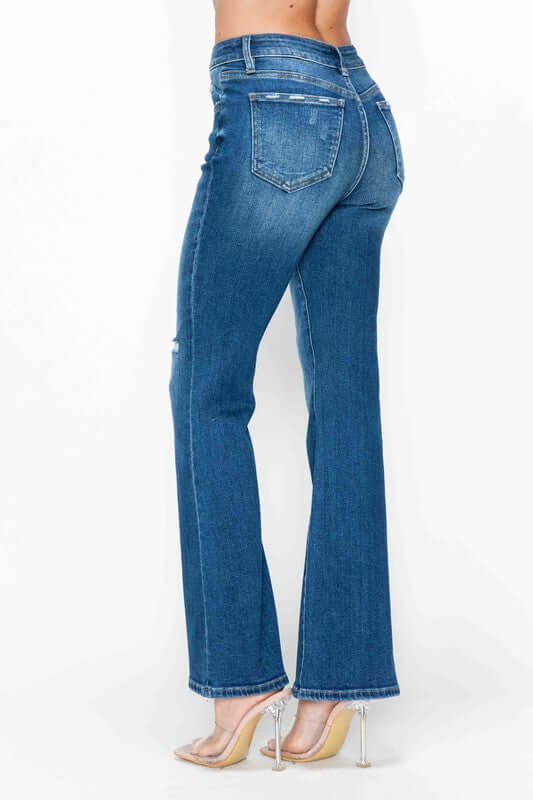 A woman showcases bytos full-size high-rise bootcut jeans with pockets, highlighting their stylish fit and design from the back.