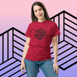 Woman wearing red "Who Uses Typewriters Anyway?" short-sleeve unisex t-shirt against geometric background.