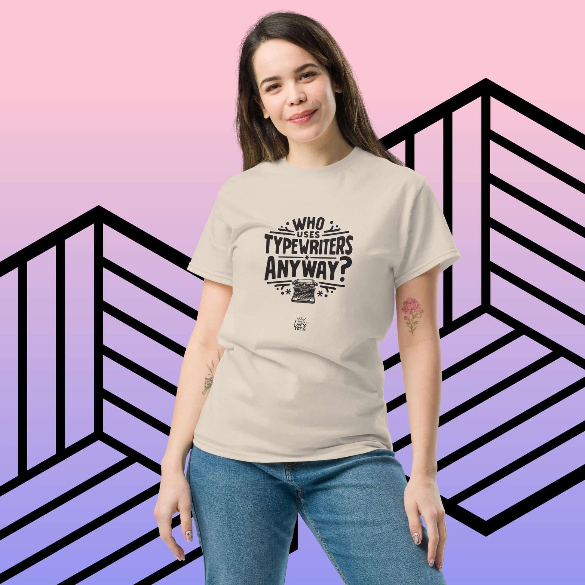 Woman wearing "Who Uses Typewriters Anyway?" short-sleeve unisex T-shirt in beige against a geometric background.