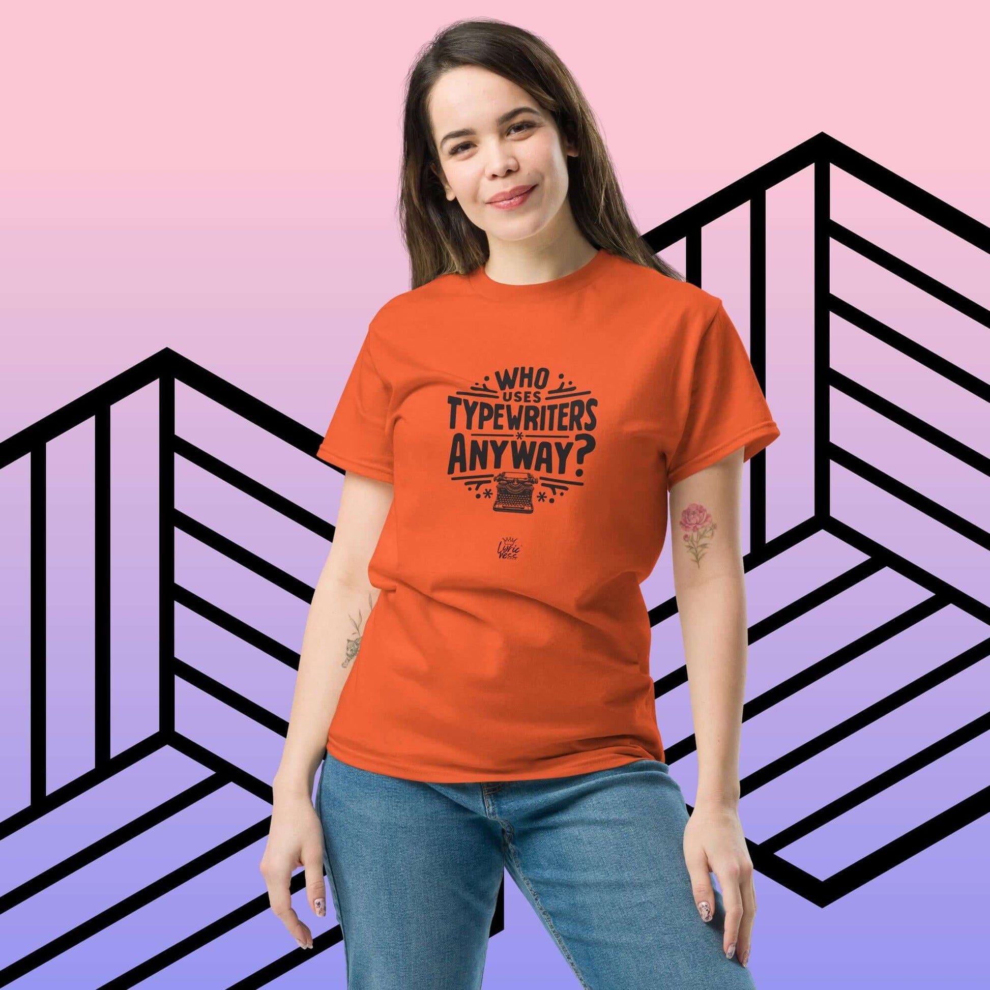 Person wearing "Who Uses Typewriters Anyway?" short-sleeve unisex t-shirt in orange against geometric background.