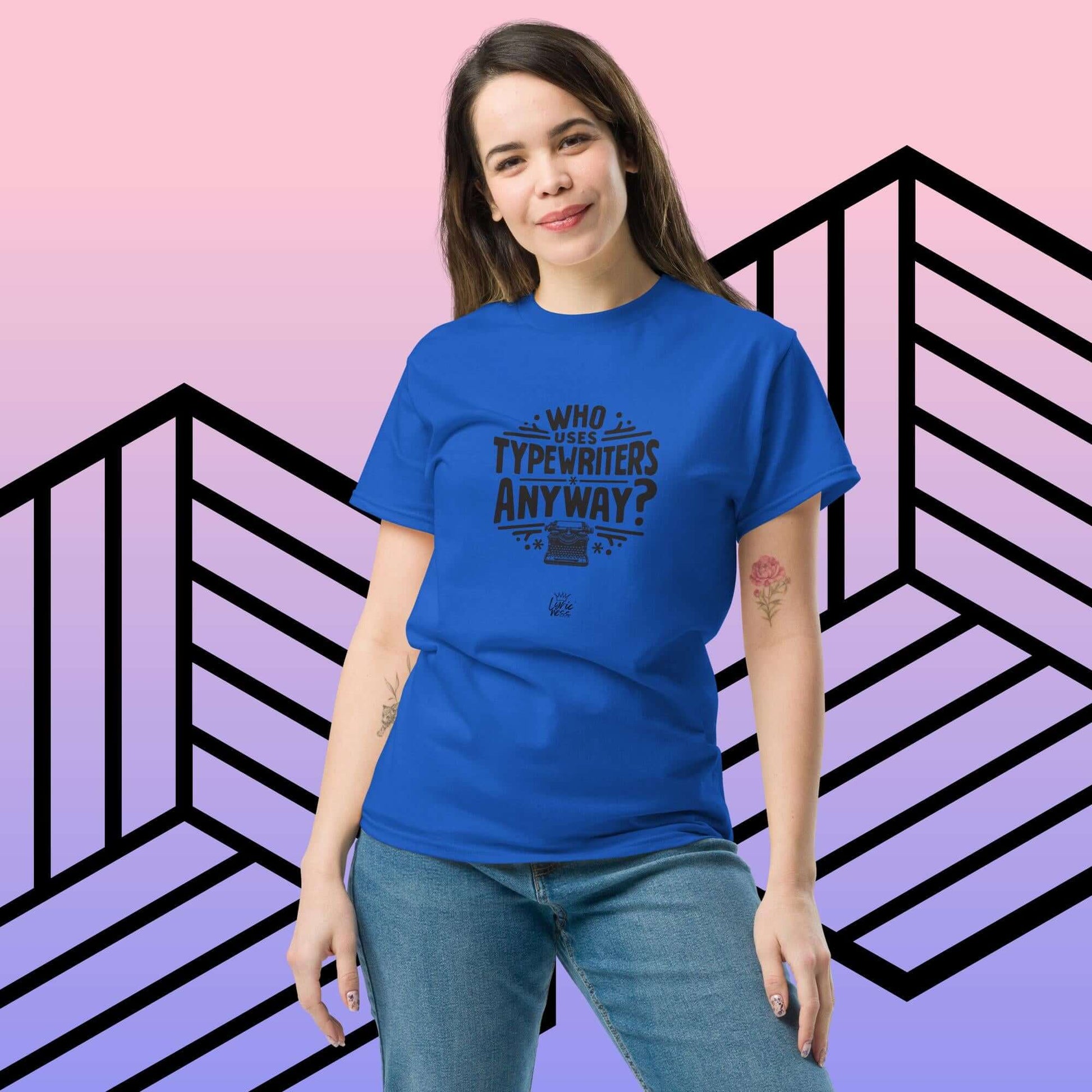 Woman wearing blue "Who Uses Typewriters Anyway?" short-sleeve unisex t-shirt, casual streetwear style.